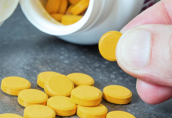 Turmeric tablets, a natural food supplement with multiple virtue — Stock Photo, Image