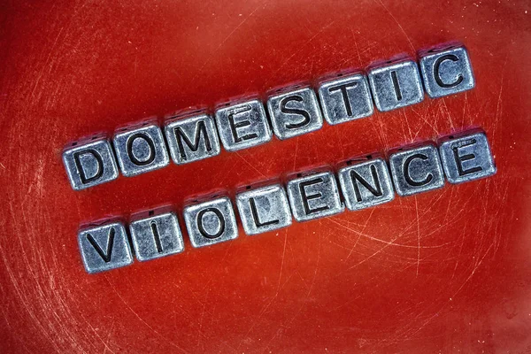 Domestric violence background concept with cubic metal letters — Stock Photo, Image