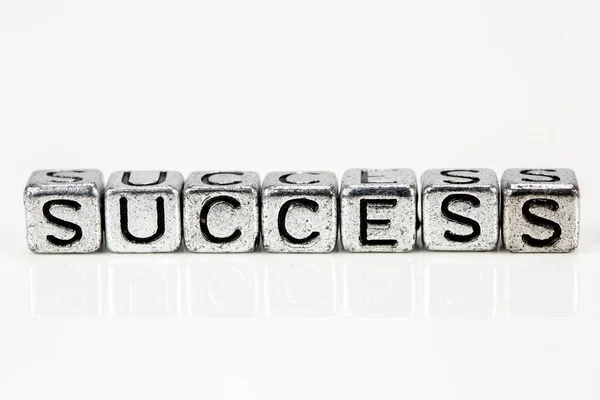 Success concept with cubic metal letters — Stock Photo, Image