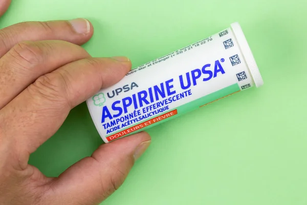 Closeup on aspirin box upsa. It is an antipyretic and pain killer holding in hand — Stock Photo, Image