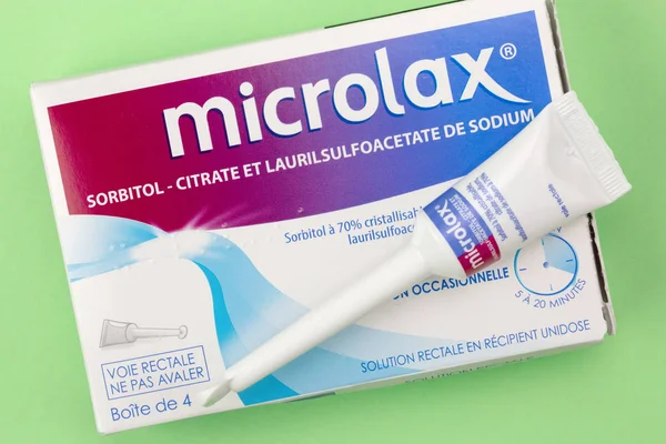 Closeup on Microlax box with its cannula on green background — Stock Photo, Image