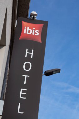 Cognac, France - February 16, 2020: Ibis hotel sign on a pole. Ibis is an international hotel company, owned by a holding company of hotels AccorHotels