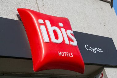Cognac, France - February 16, 2020: Ibis hotel sign on a pole. Ibis is an international hotel company, owned by a holding company of hotels AccorHotels