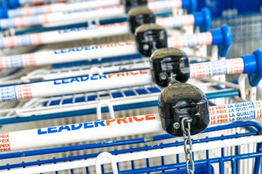 Cognac, France - February 16, 2020:LeaderPrice Supermarket shopping trolleys aligned and stored in an empty supermarket with no customers