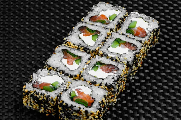 Japanese rolls on a dark textured background — Stock fotografie