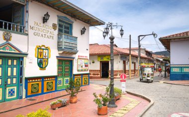 GUATAPE, COLOMBIA - OCTOBER 11, 2016: Colorful streets and decor clipart