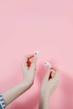 Air Pods pro. with Wireless Charging Case. New Airpods pro on pink background. Airpodspro. female headphones. wireless headphones in hand clipart