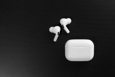 Air Pods Pro. with Wireless Charging Case. New Airpods pro on black background. Airpods Pro. Copy space. clipart