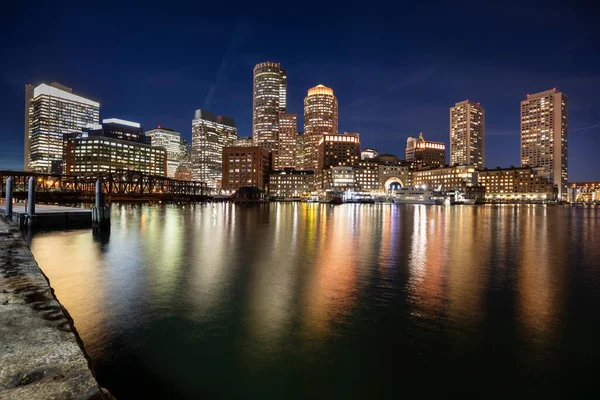 Downtown city view of Boston Massachusetts looking of the riverfront harbor at night