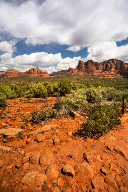 Sand stone butte and mesa formation on the hiking trail near the town of Sedona Arizona USA clipart