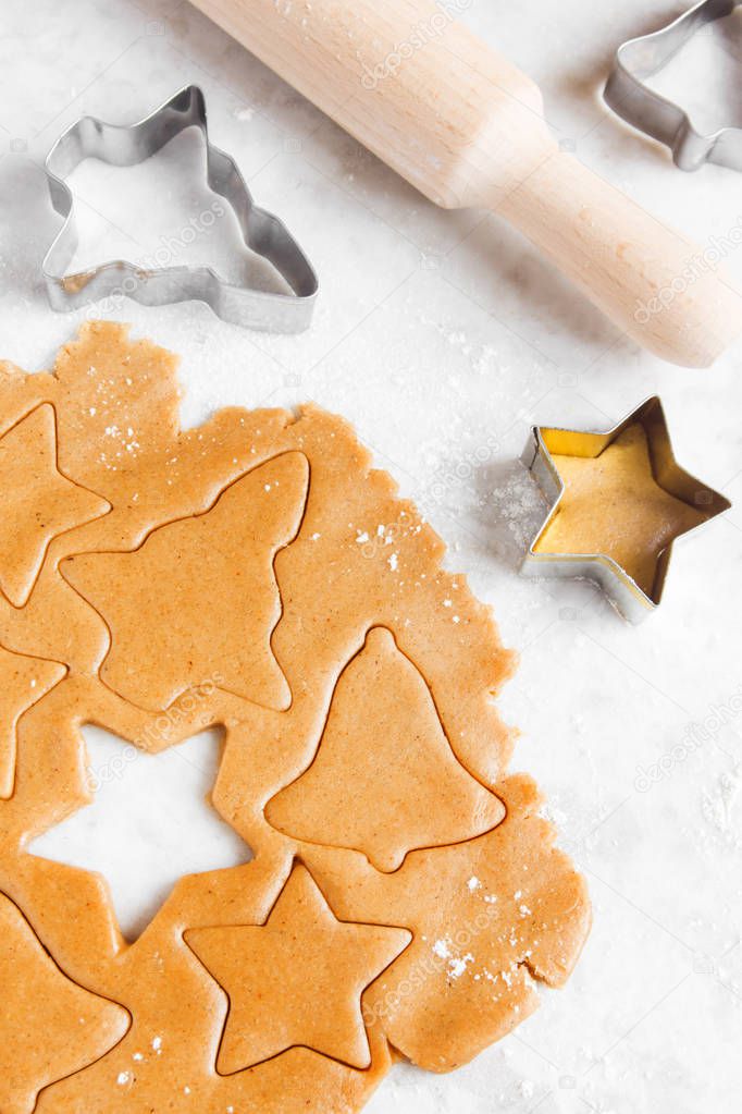 Preparing Christmas gingerbread cookies with cutter, ginger dough - homemade festive Christmas bakery