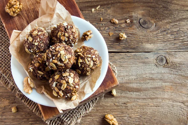 Healthy organic energy granola bites with nuts, cacao, banana and honey - vegan vegetarian raw snack or meal