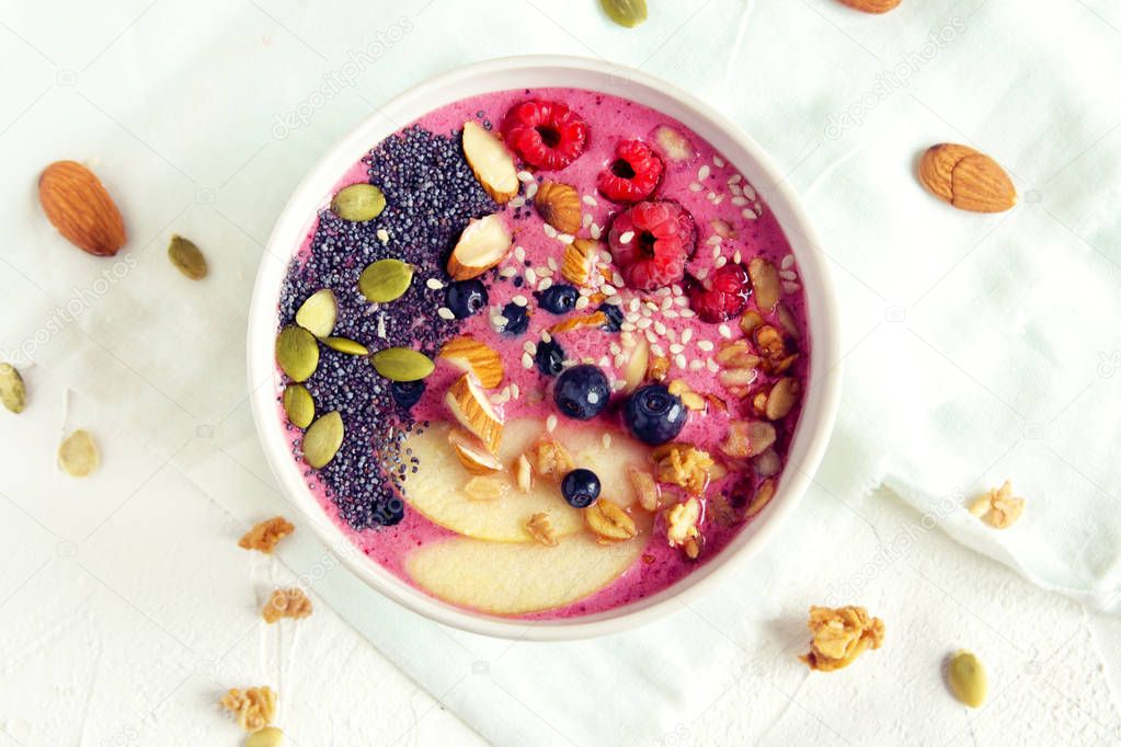 Smoothie bowl with fresh berries, nuts, seeds and homemade granola for healthy breakfast