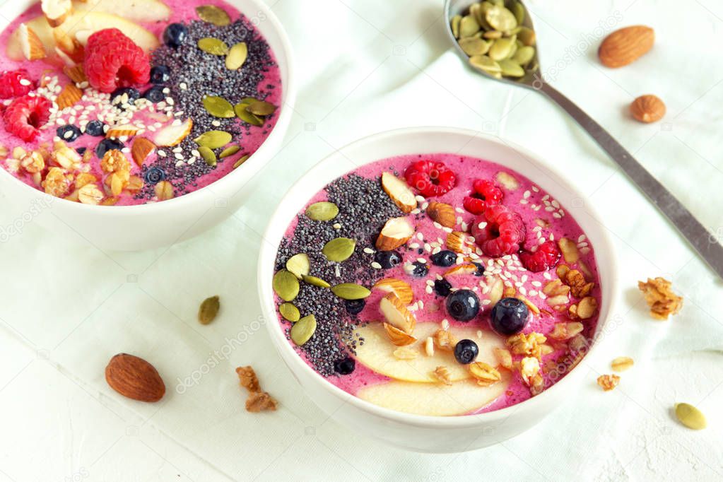 Smoothie bowl with fresh berries, nuts, seeds and homemade granola for healthy breakfast