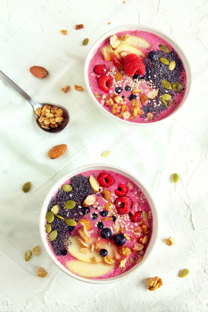 Smoothie bowl with fresh berries, nuts, seeds and homemade granola for healthy breakfast