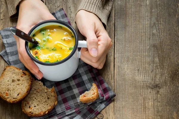 Woman hands holding mug of vegetable soup with parsley and croutons over wooden background - healthy winter vegetarian food — Stock Image Woman Hands Holding Mug Vegetable Soup Parsley Croutons Wooden Background Stock Image
