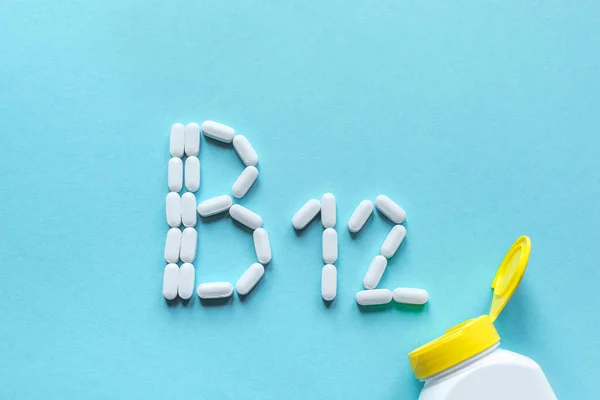 Witamina B12 Białe Tabletki Tworzące Kształt Alfabetu B12 Niebieskim Tle — Zdjęcie stockowe