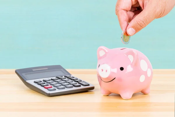 Piggy Bank Hand Putting Insert Coin Calculator Desk Light Blue — Stock Photo, Image