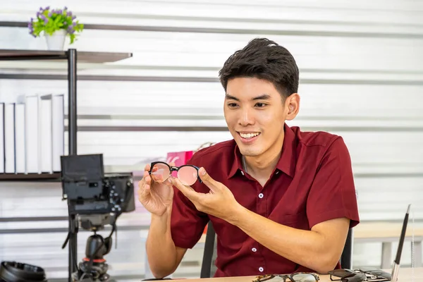 Young Asian male online merchant blogger using camera to live video to  review and sell glasses. Social media, Influencer, and online shopping  concept. | Stock Images Page | Everypixel