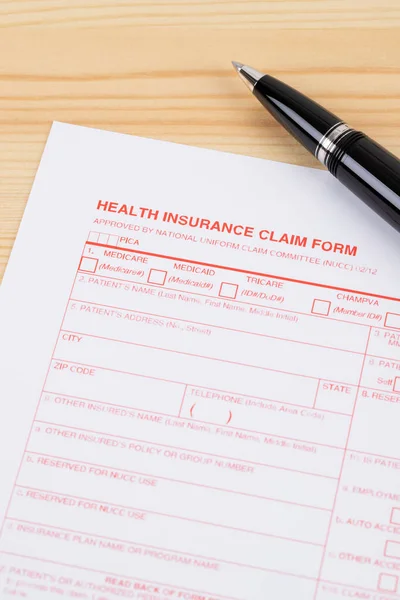 Health Insurance Claim Form Pen Wooden Desk — Stock Photo, Image