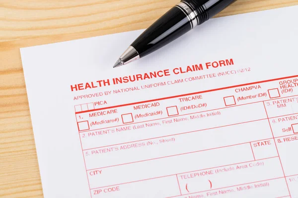 Health Insurance Claim Form Pen Wooden Desk — Stock Photo, Image