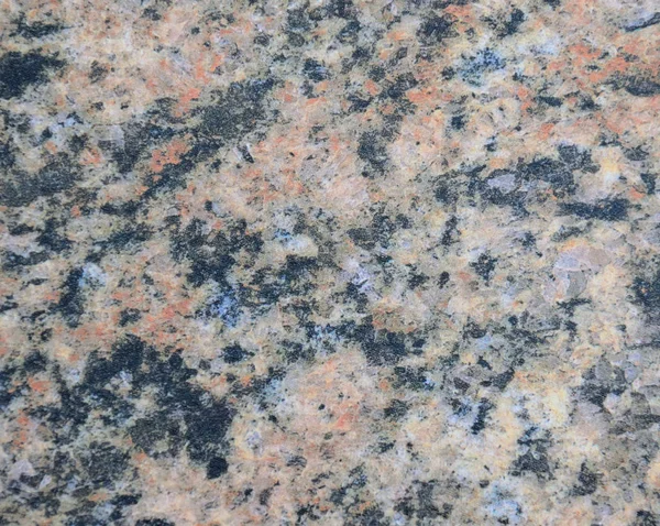 Dark granite, black-brown pattern of natural stone on a polished surface.
