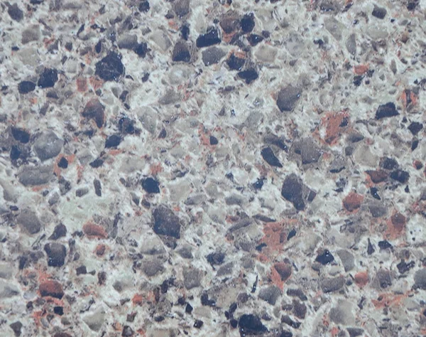 Gray granite with black and white spots, natural stone texture close-up. Background.