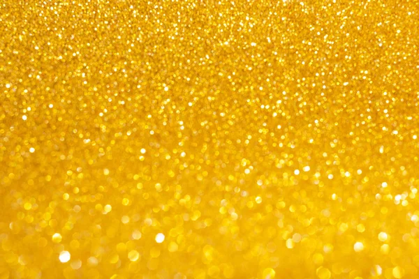 New Year,Xmas Golden abstract sparkles or glitter lights.2020.Defocused circles bokeh or particles.Template for design.Blurred golden holiday abstract glitter defocused background with blinking stars.