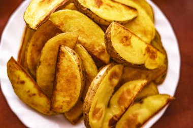 Hazır patatesleri beyaz tabakta yakın plan. Kızarmış patates, beyaz tabakta ahşap bir masa üzerinde. Direk olarak Fast Fast Fast Food.Fast Fast Fast Fast Food. Altın Lezzetli Patates Düğünleri, üst düzey yaşam tarzı,
