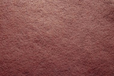 Turuncu renk arka planda. Kumaş dokusunun yüzeyi. Fotokopi alanı ile arka plan için renkli keçeli kumaş. Keçeli kumaş.