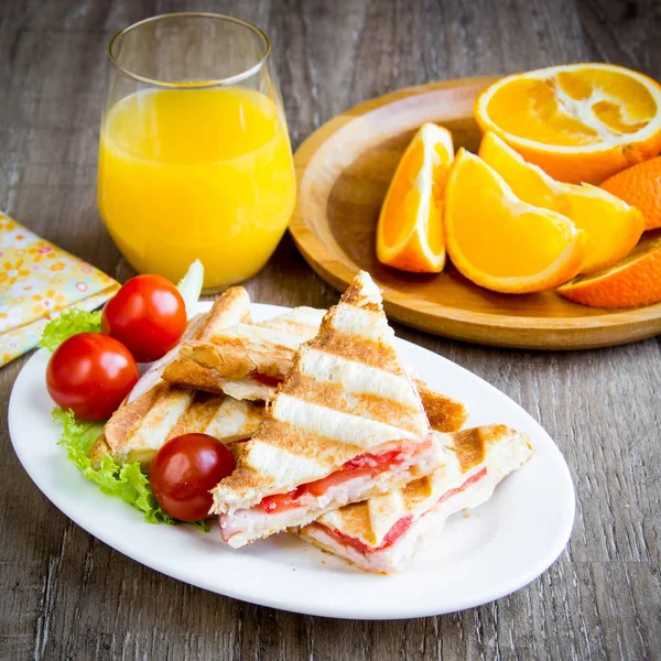 Grilled sandwich, toast with cheese, ham and tomato, tasty Europ