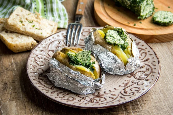Baked potatoes with herbs butter, with green homemade butter, de — Stock Photo, Image