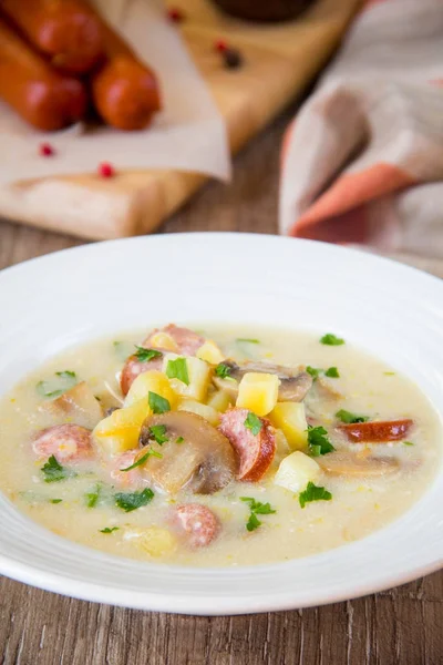 Cheese cream soup with mushrooms, potatoes, smoked sausage — Stock Photo, Image