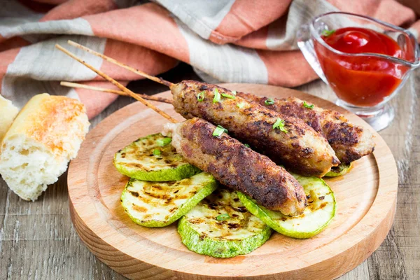 Meat kebab from beef, pork, lamb on skewers with grilled zucchin — Stock Photo, Image