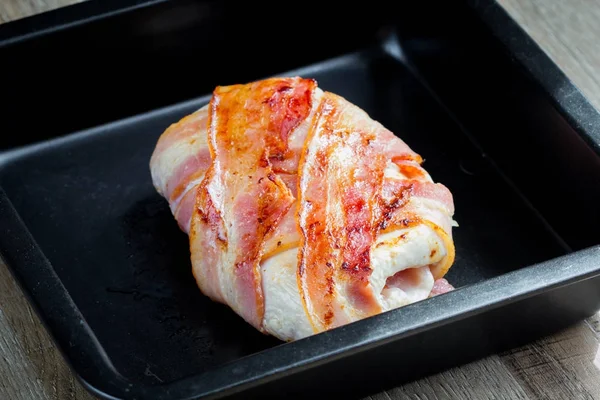 Chicken wrapped in bacon stuffed with soft cheese in form, tasty