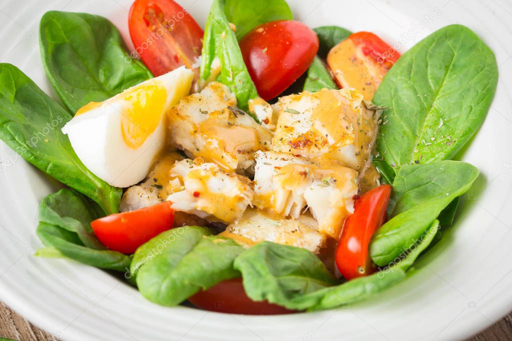 Salad with spinach, white fish, cod, seabass, dorado,  cherry to