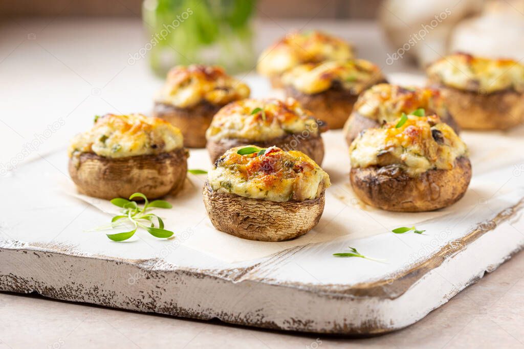 Stuffed mushrooms with cheese, delicious baked appetizer, traditional starter, golden crust