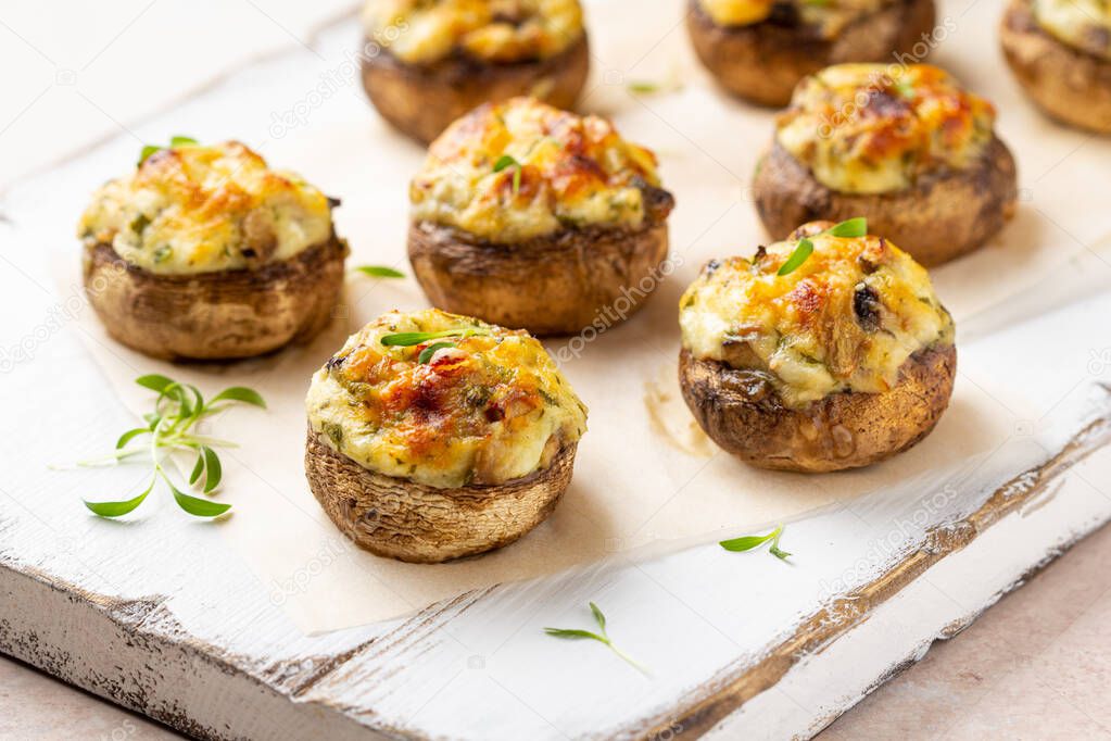 Stuffed mushrooms with cheese, delicious baked appetizer, traditional starter, golden crust