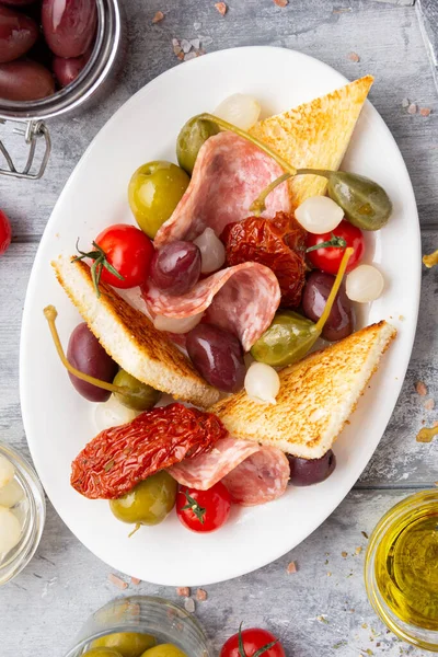 Italian Antipasti Olives Capers Sun Dried Tomatoes Olive Oil Bread — Stock Photo, Image