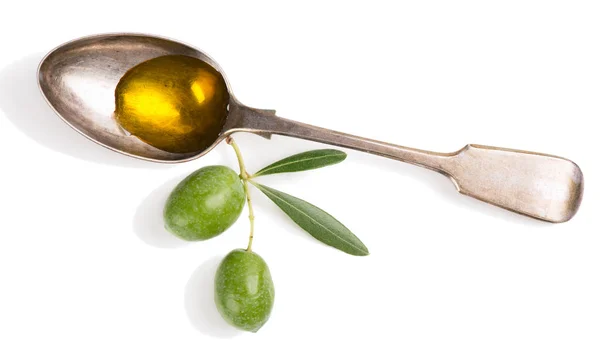Olijfolie en takje met olijven. Stockfoto