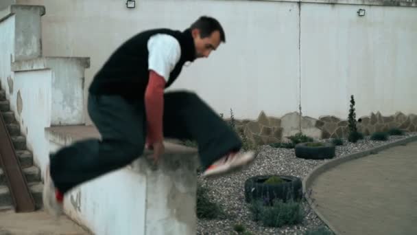 Hij traint parkour. Springt op de reling op een koude herfstdag. Doet een backflip. Slim springen. Parkour. — Stockvideo