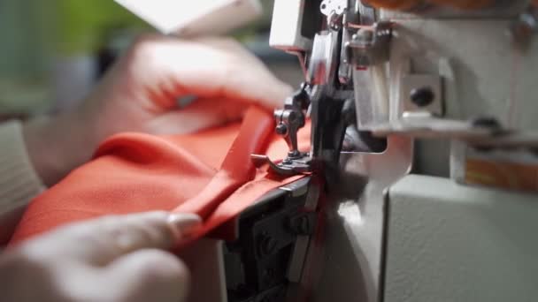 Female master tailor in making preparations for the red dress — Stock Video