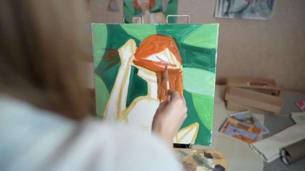 Artista menina em uma pequena sala pinta um quadro . — Vídeo de Stock
