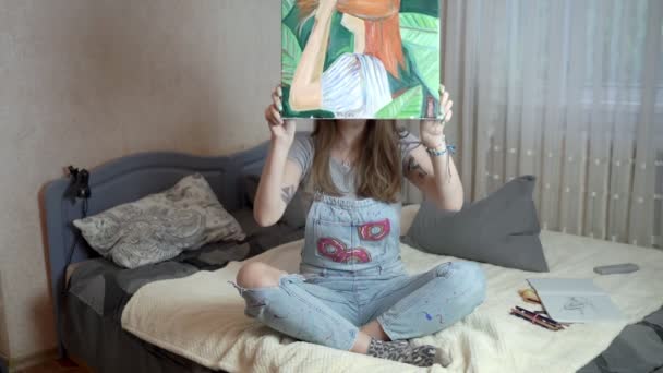 Portret van een mooi close-up kunstenaar meisje die voltooide tekening. — Stockvideo