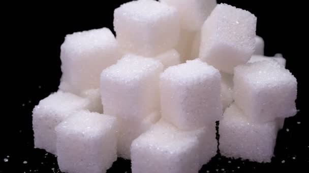 Refined sugar cubes close up rotate on a black background — Stock Video