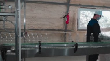 Saf içme suyu bitkisi. Girişimcilik için nakliyeci. Fabrika işçileri şişeleri suyla doldurmak için düzenler ve paketlenmiş su şişelerini kabul eder. 4k