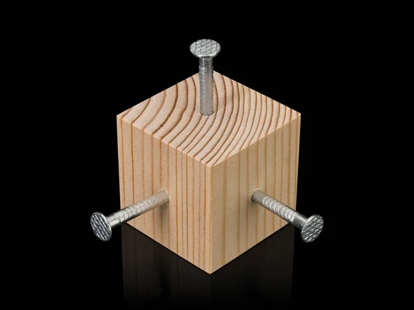 Cubo de madeira e três pregos de aço — Fotografia de Stock
