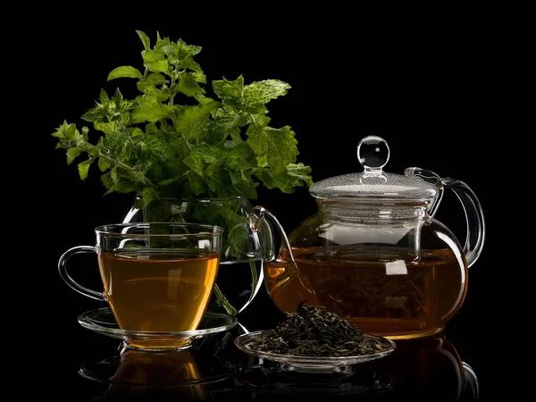 Färsk mynta, te blad grönt te och en drink i ware från glas — Stockfoto