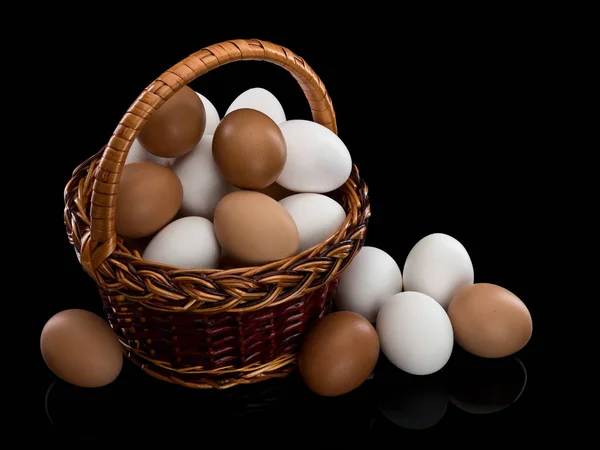 Basket full of white and brown eggs — Stock Photo, Image
