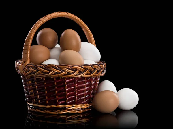 Basket full of white and brown eggs — Stock Photo, Image